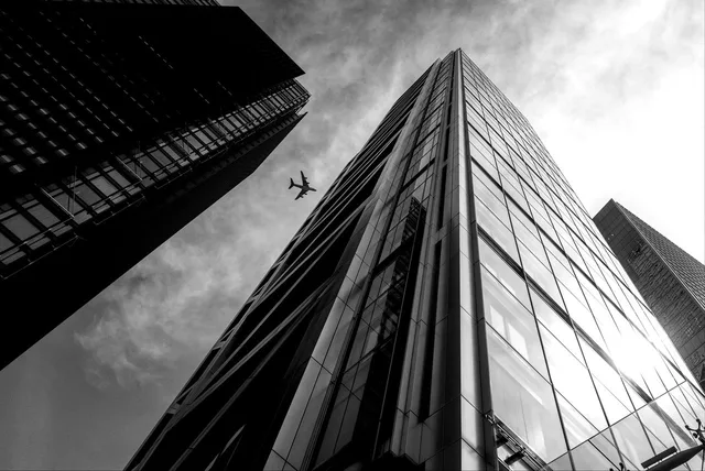 london, uk, reflection, glass, sun, light, summer, mono, city, nature, skyscraper, building, plane. What does a brand strategy agency do for UK businesses?